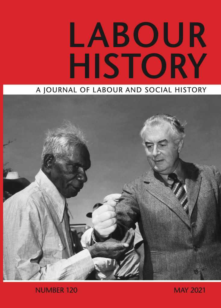 Journal cover for Labour History, a Journal of Labour and Social History. Bright red background featuring a black and white photograph of two mean, one man is holding a fist above the open palm of the other. Black minimalistic text for the journal's title. 