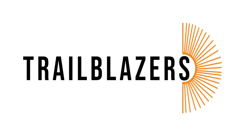 The 'TRAILBLAZERS' logo in black bold text with an open book fan in orange.
