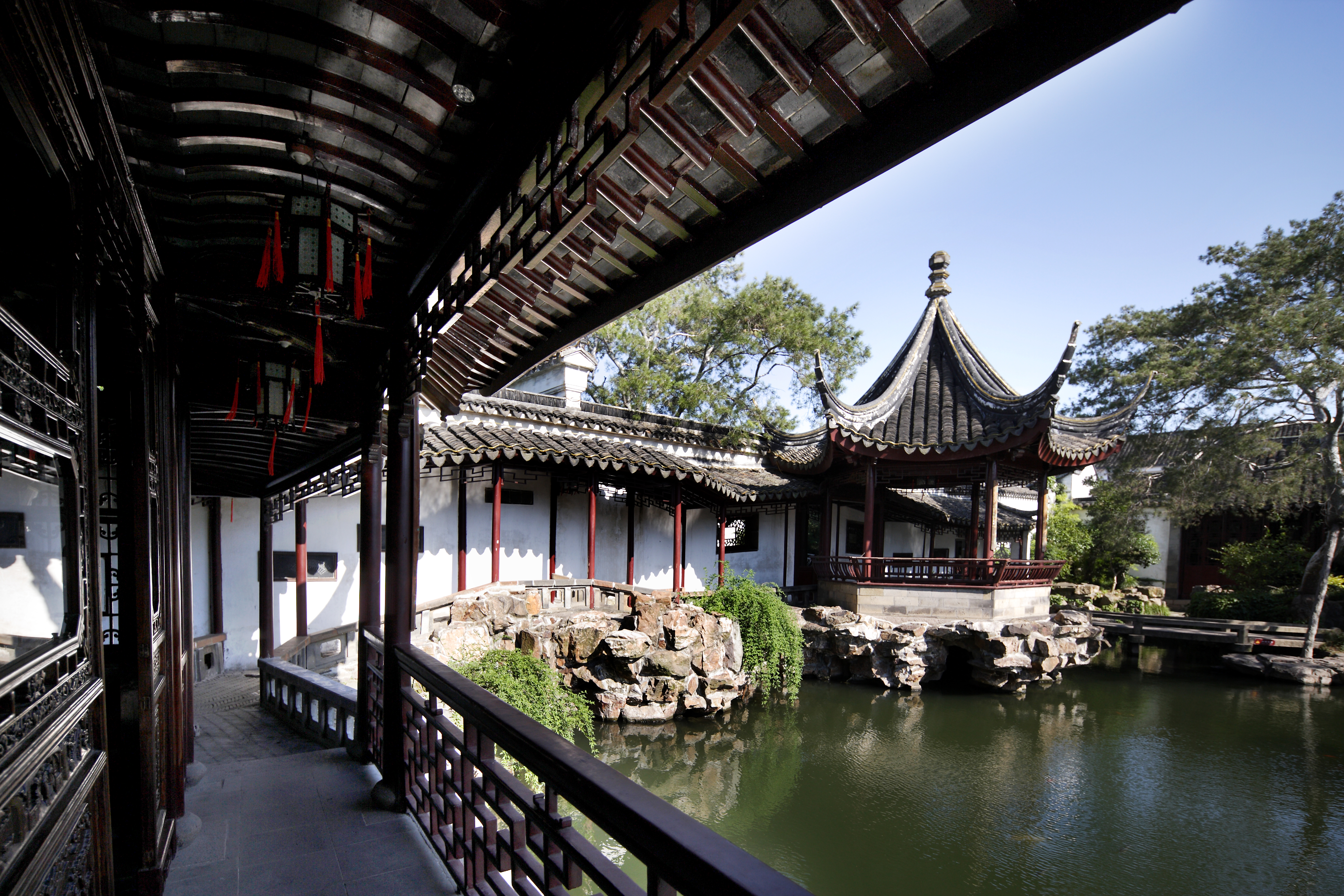 A walkway leading to a pavilion by the water in the Master of the Nets Garden; photo by Liang Zhang, 2013